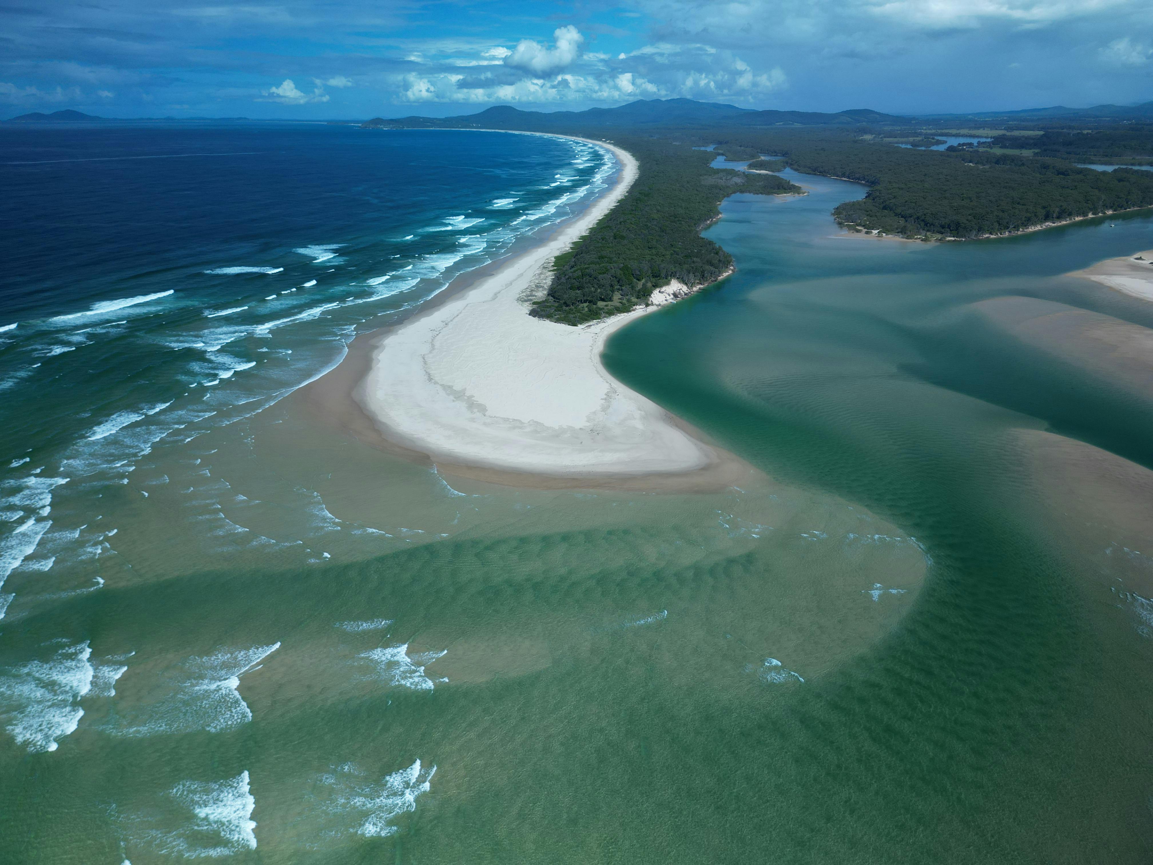 Aerial View of Waves Brushing a Sandy Beach