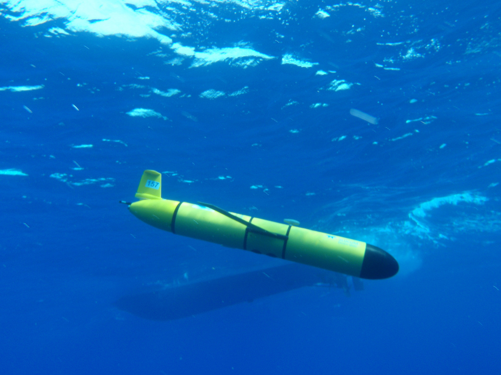 Yellow underwater glider with wings beneath the ocean surface