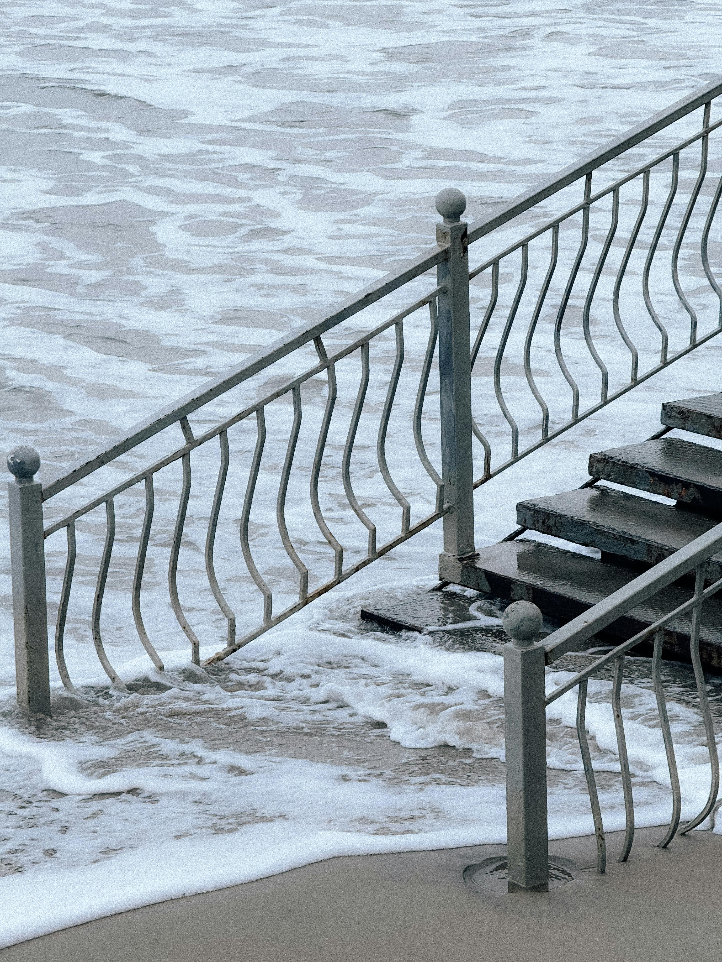 Coastal Staircase Descending into Ocean Waves